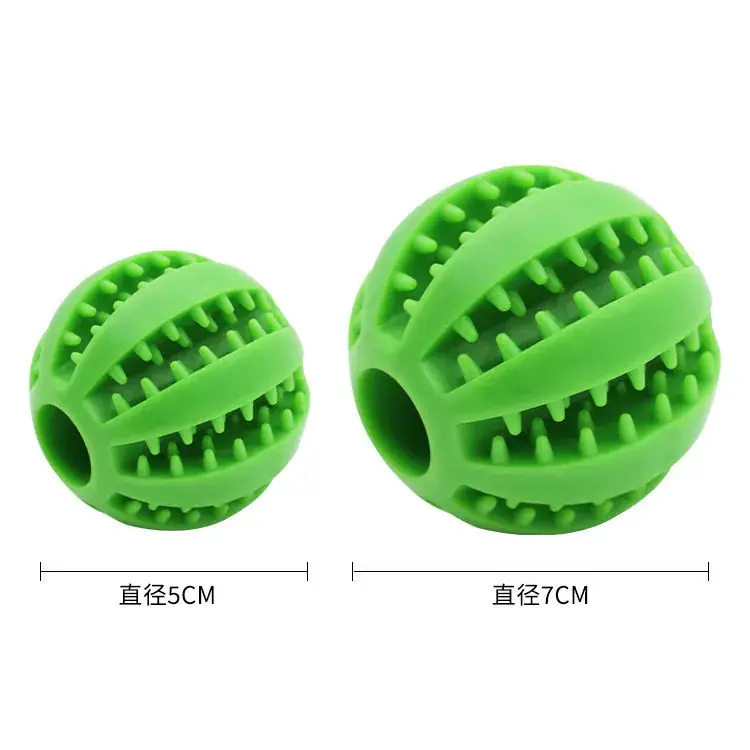Dog playing with a treat ball